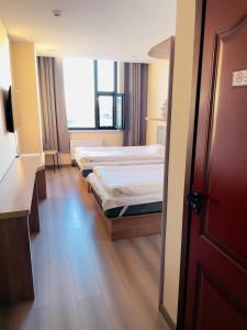 a hospital room with two beds and a door at Onon-Ulz restaurant and hotel in Uldz
