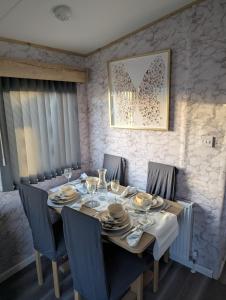 a dining room with a table with chairs and a picture at Arnside abode in Morecambe
