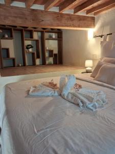 a bedroom with a bed with towels on it at La casina di Zora in Lorenzana