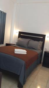 a bed with two white towels on top of it at Hotel Arda Bali in Negara +142 photos