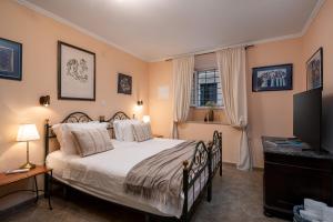 a bedroom with a large bed and a television at Antaeus Old Town Residence in Dubrovnik