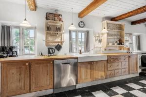 a kitchen with wooden cabinets and a stainless steel dishwasher at SL349-Slagelse-Kongsmarkvej-259 in Slagelse