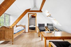 a room with a bed and a table and chairs at SL349-Slagelse-Kongsmarkvej-259 in Slagelse