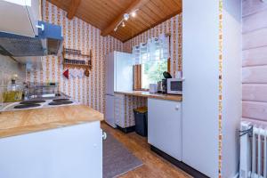 a kitchen with white cabinets and a counter top at VAR101-Arjaeng in Årjäng