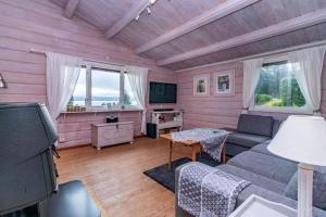 a living room with a couch and a tv at VAR101-Arjaeng in Årjäng