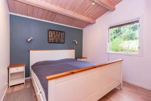 a bedroom with a bed and a window at VAR101-Arjaeng in Årjäng