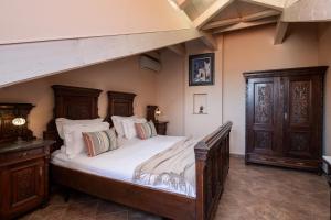 a bedroom with a large bed with white sheets at Antaeus Old Town Residence in Dubrovnik