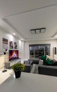 a living room with a couch and a tv at Cozy Clark Stay 3BR Condo in Clark