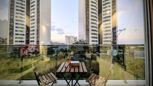 a balcony with a table and chairs and buildings at Cozy Clark Stay 3BR Condo in Clark