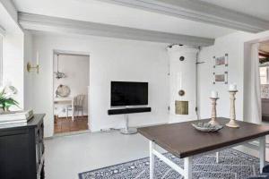 a living room with a table and a television at SKA117-Simrisham-Skepparegatan-6 in Simrishamn