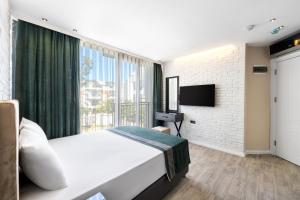 a bedroom with a large bed and a large window at Nivasole Lara Pure Comfort & Style in Antalya