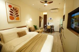 a hotel room with a bed and a dining room at Hanoi Aurelia Stay in Hanoi