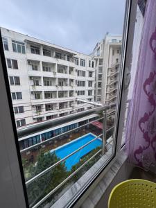 a view of a pool from a window at Mesdheu ApartHotel in Durrës