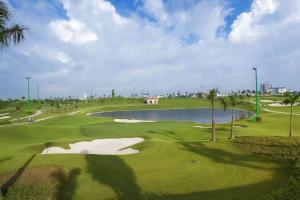 a view of a golf course with a pond at Căn hộ 2PN THE EMERALD GOLF VIEW in Thuan An