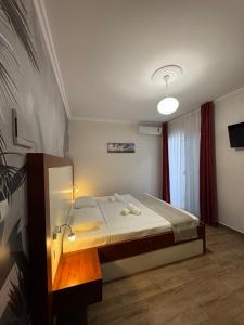 a bedroom with a bed in a room at Mesdheu ApartHotel in Durrës +5 photos