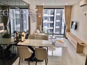 a living room with a glass table and chairs at Căn hộ 2PN THE EMERALD GOLF VIEW in Thuan An +6 photos
