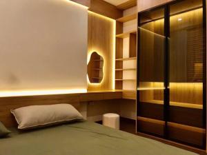 a bedroom with a bed and a book shelf at Căn hộ 2PN THE EMERALD GOLF VIEW in Thuan An