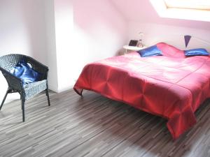 a bedroom with a large bed and a chair at Ferienwohnung Stoetera in Malente
