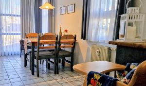 a dining room with a table and some chairs at Ferienwohnung Stoetera in Malente