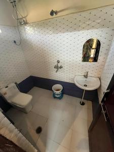 a small bathroom with a toilet and a sink at Rv stay pushkar in Pushkar +24 photos