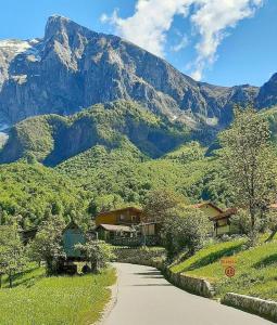 a winding road with a mountain in the background at Hiša Planica in Kobarid