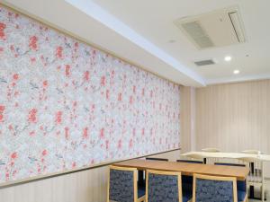 a classroom with tables and chairs in front of a floral wall at ALA HOTEL KYOTO in Kyoto +56 photos