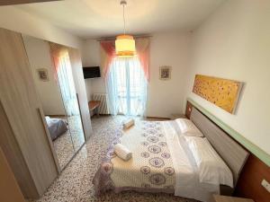 a bedroom with a bed and a large window at Hotel San Donnino in Fidenza