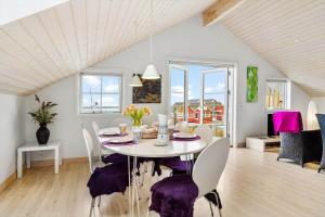 a dining room with a white table and chairs at 20124-Samso-Maarup-Havn-3 in Nordby