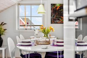 a white dining room with a white table and chairs at 20124-Samso-Maarup-Havn-3 in Nordby +19 photos