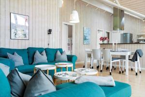 a living room with a blue couch and a table at 20134-Samso-Heden-19 in Nordby