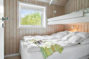 a bed in a room with a window at 20134-Samso-Heden-19 in Nordby