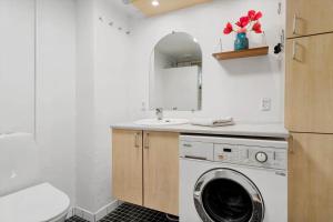 a bathroom with a washer and a sink and a washing machine at 20120-Samso-Nordby-Hovedgade-22 in Nordby