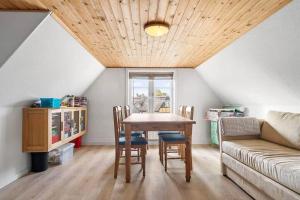 a living room with a table and a couch at 20120-Samso-Nordby-Hovedgade-22 in Nordby