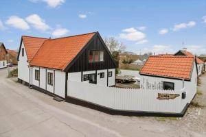a house with an orange roof and a white fence at 20120-Samso-Nordby-Hovedgade-22 in Nordby +29 photos