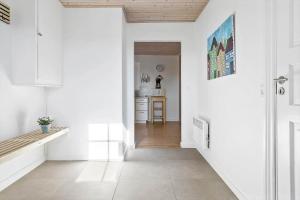 a hallway with white walls and a wooden ceiling at 20616-Samso-Norreskiftevej-40 in Brundbymark