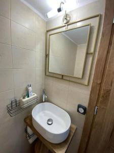 a bathroom with a white sink and a mirror at Vattediko in Pyrgi +17 photos