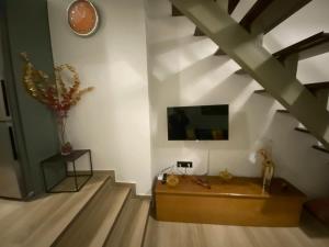 a living room with a tv and a wooden coffee table at Vattediko in Pyrgi