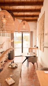 a large living room with a table and chairs at Finca las Calmas Adults Only Boutique Retreat & Dining Experience in Moraleda de Zafayona