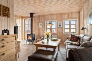 a living room with a couch and a fireplace at 20613-Samso-Halemejsevej-8 in Nordby +17 photos