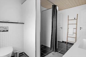 a bathroom with a shower and a toilet at 20212-Samso-Saelvig-50 in Sælvig +37 photos