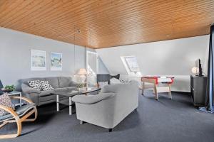 a living room with a couch and a table at 20212-Samso-Saelvig-50 in Sælvig