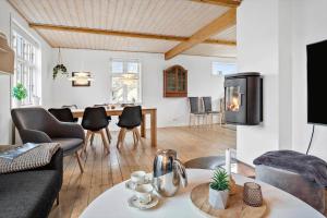a living room with a table and chairs at 20310-Ballen-Strandvejen-8 in Ballen