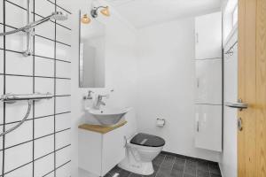 a white bathroom with a sink and a toilet at 20310-Ballen-Strandvejen-8 in Ballen +29 photos