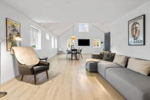 a living room with a couch and a table at 20417-Samso-Ballenvej-26 in Ballen