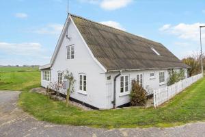 a white house with a black roof at 20417-Samso-Ballenvej-26 in Ballen