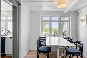 a kitchen and dining room with a table and chairs at 20322-Samso-Bakkevej-7 in Brundbymark
