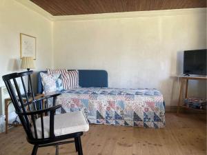 a living room with a couch and a chair at 20322-Samso-Bakkevej-7 in Brundbymark