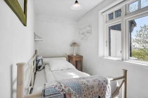 a white room with a bed and a window at 20322-Samso-Bakkevej-7 in Brundbymark
