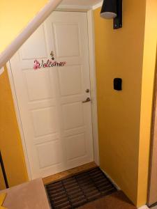 a white garage door with a welcome sign on it at Ivory & Rose Studio in Tartu