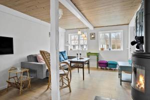 a living room with a couch and a dining room at 20313-Samso-Orby-Hovedgade-53 in Brundbymark